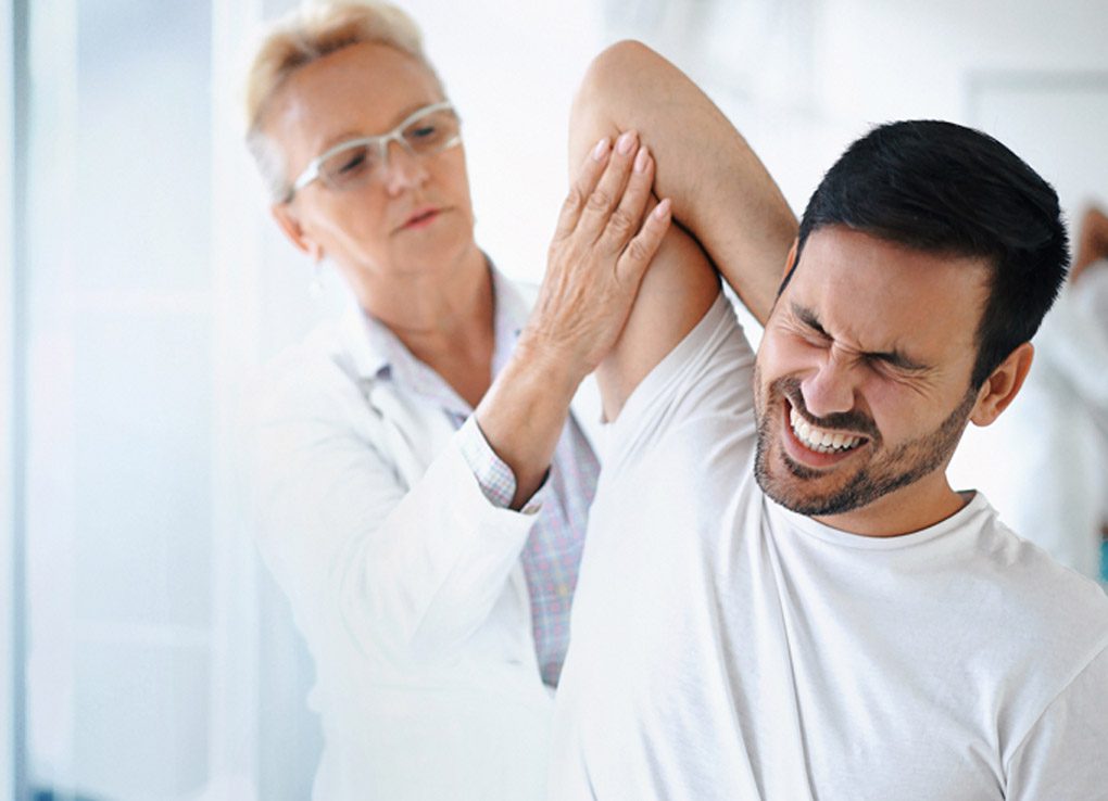 Male-patient-in-pain-from-shoulder-injuries-receiving-treatment-at-a-personal-injury-clinic-in-San-Antonio